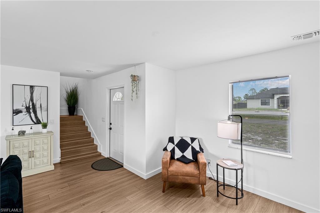 3303 6th Street Southwest Lehigh Acres, FL 33976 - Photo 4 of 23 a living room with furniture and a wooden floor