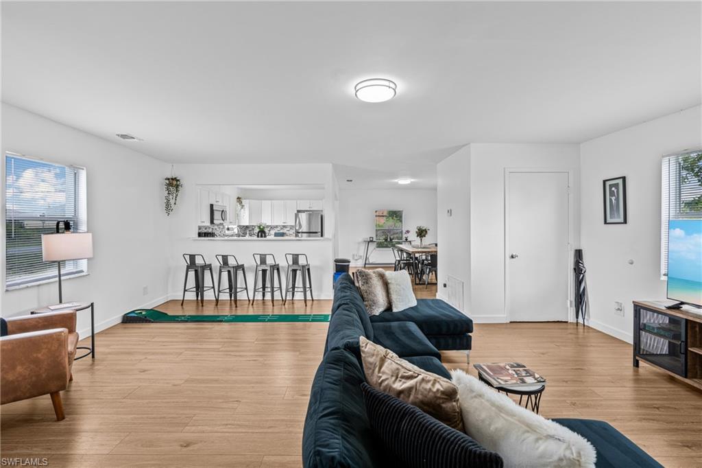 3303 6th Street Southwest Lehigh Acres, FL 33976 - Photo 5 of 23 a living room with furniture and wooden floor