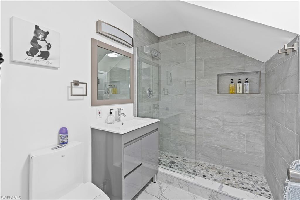 3303 6th Street Southwest Lehigh Acres, FL 33976 - Photo 10 of 23 a bathroom with a sink a toilet and shower