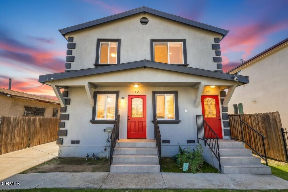 a front view of a house with wooden fence