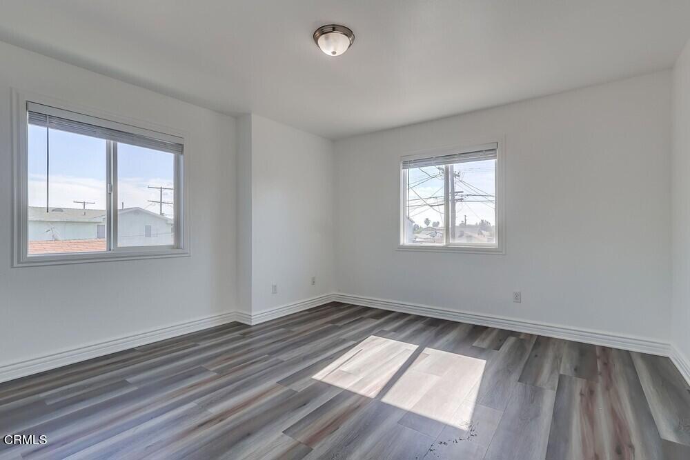 140 East 101st Street Los Angeles, CA 90003 - Photo 14 of 22 an empty room with wooden floor and windows