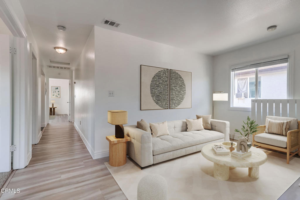 140 East 101st Street Los Angeles, CA 90003 - Photo 3 of 22 a living room with furniture and a wooden floor