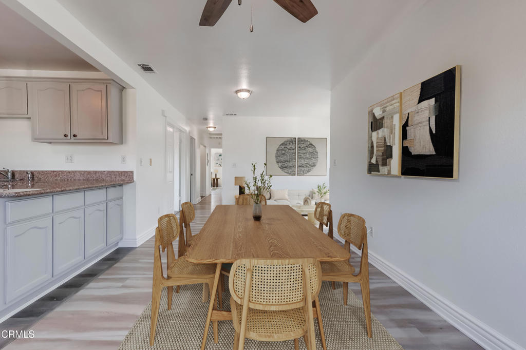 140 East 101st Street Los Angeles, CA 90003 - Photo 4 of 22 a view of a dining room with furniture and wooden floor