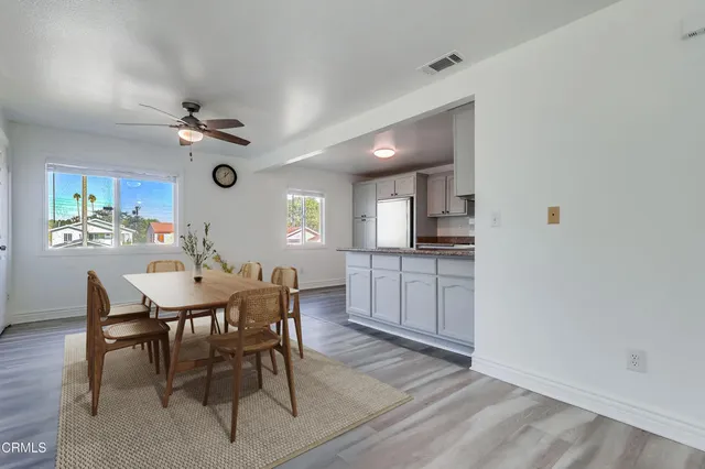 a view of a dining room with furniture and a kitchen