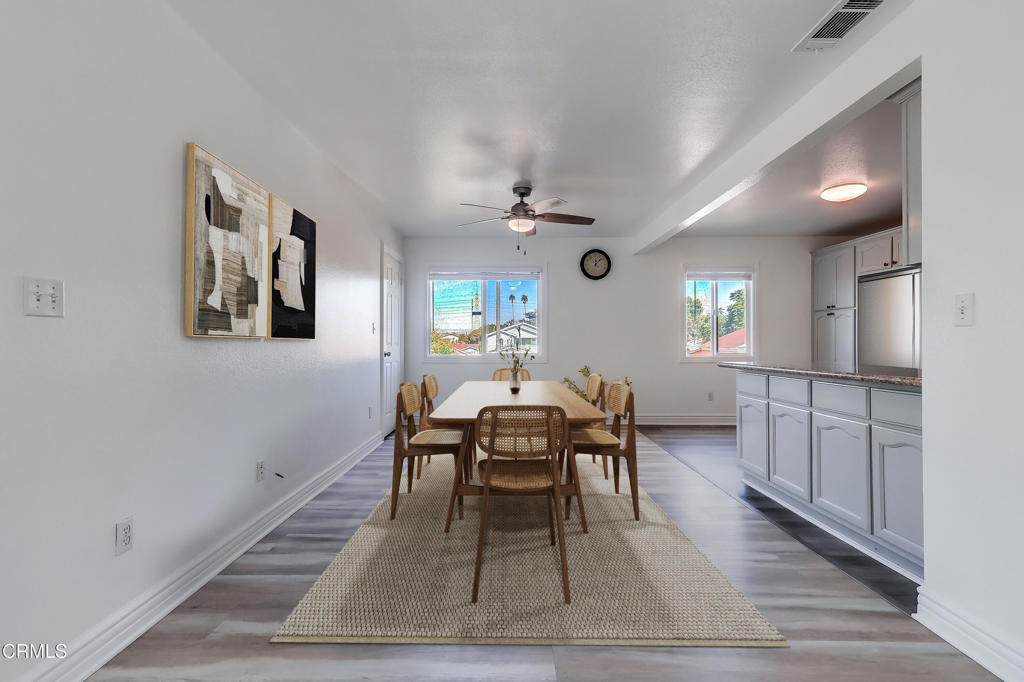 140 East 101st Street Los Angeles, CA 90003 - Photo 7 of 22 a dining room with wooden floor and a rug