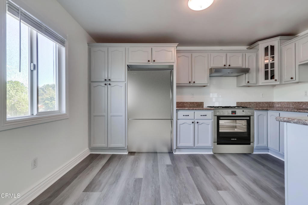 140 East 101st Street Los Angeles, CA 90003 - Photo 9 of 22 a kitchen with a refrigerator and a stove top oven