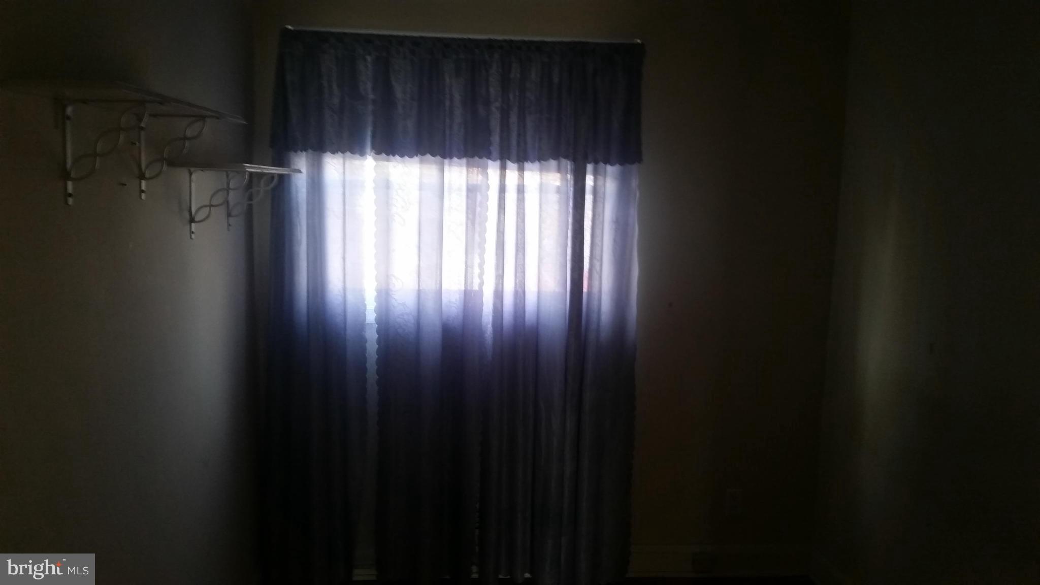 1358 Halstead Road Parkville, MD 21234 - Photo 5 of 9 a view of an empty room with wooden floor and a window