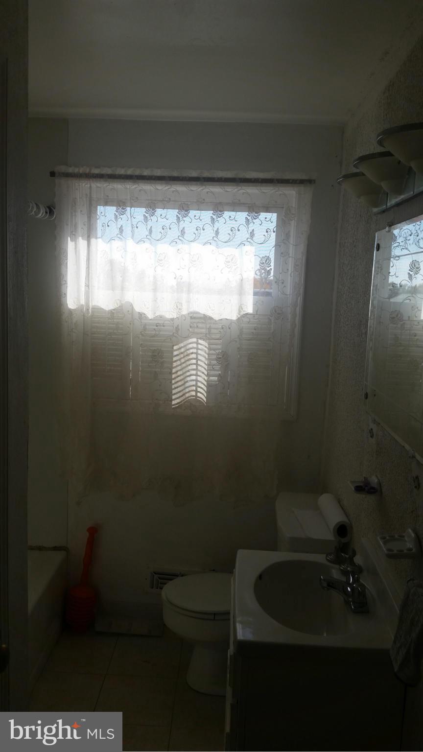1358 Halstead Road Parkville, MD 21234 - Photo 8 of 9 a bathroom with a toilet and a sink