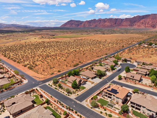 225 Falcon Court Ivins, UT 84738 - Photo 37 of 47 Aerial perspective of suburban area with a mountainous background and a desert landscape