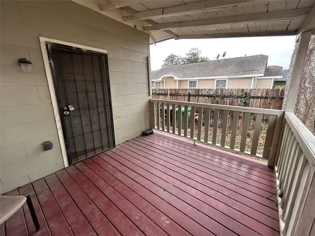 a view of balcony with wooden floor