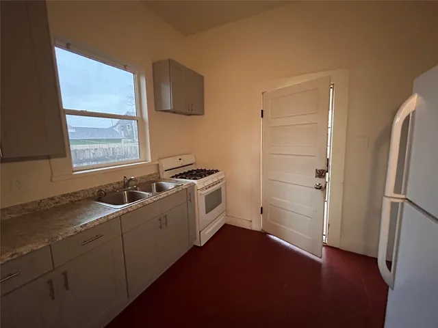 a kitchen with a sink cabinets and appliances