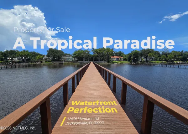 a view of building with lake and trees in the background