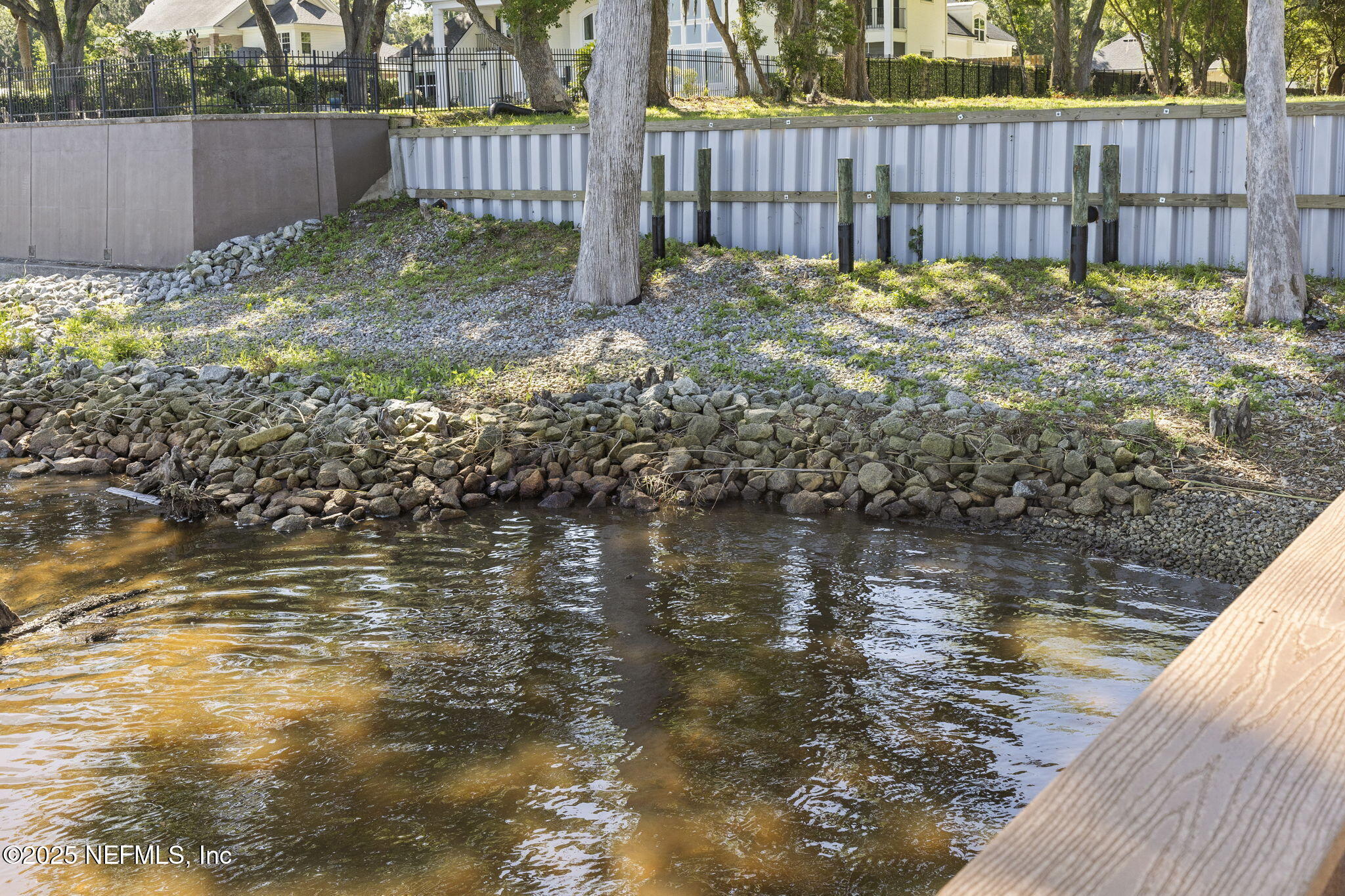 12638 Mandarin Road Jacksonville, FL 32223 - Photo 13 of 33 a view of a backyard with large trees and wooden fence