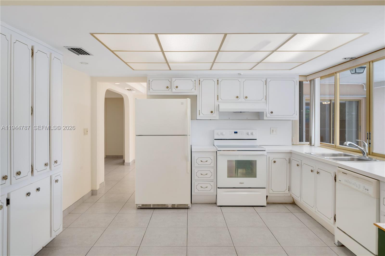 5524 Cleveland Street Hollywood, FL 33021 - Photo 13 of 36 a kitchen with stainless steel appliances a stove sink and refrigerator