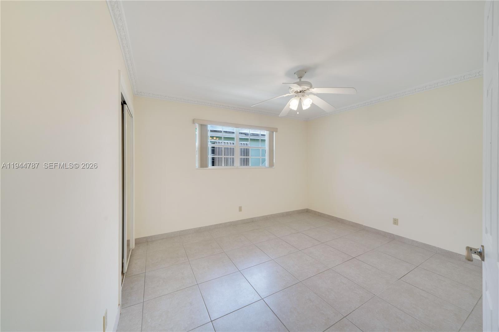 5524 Cleveland Street Hollywood, FL 33021 - Photo 23 of 36 an empty room with a ceiling fan and a window