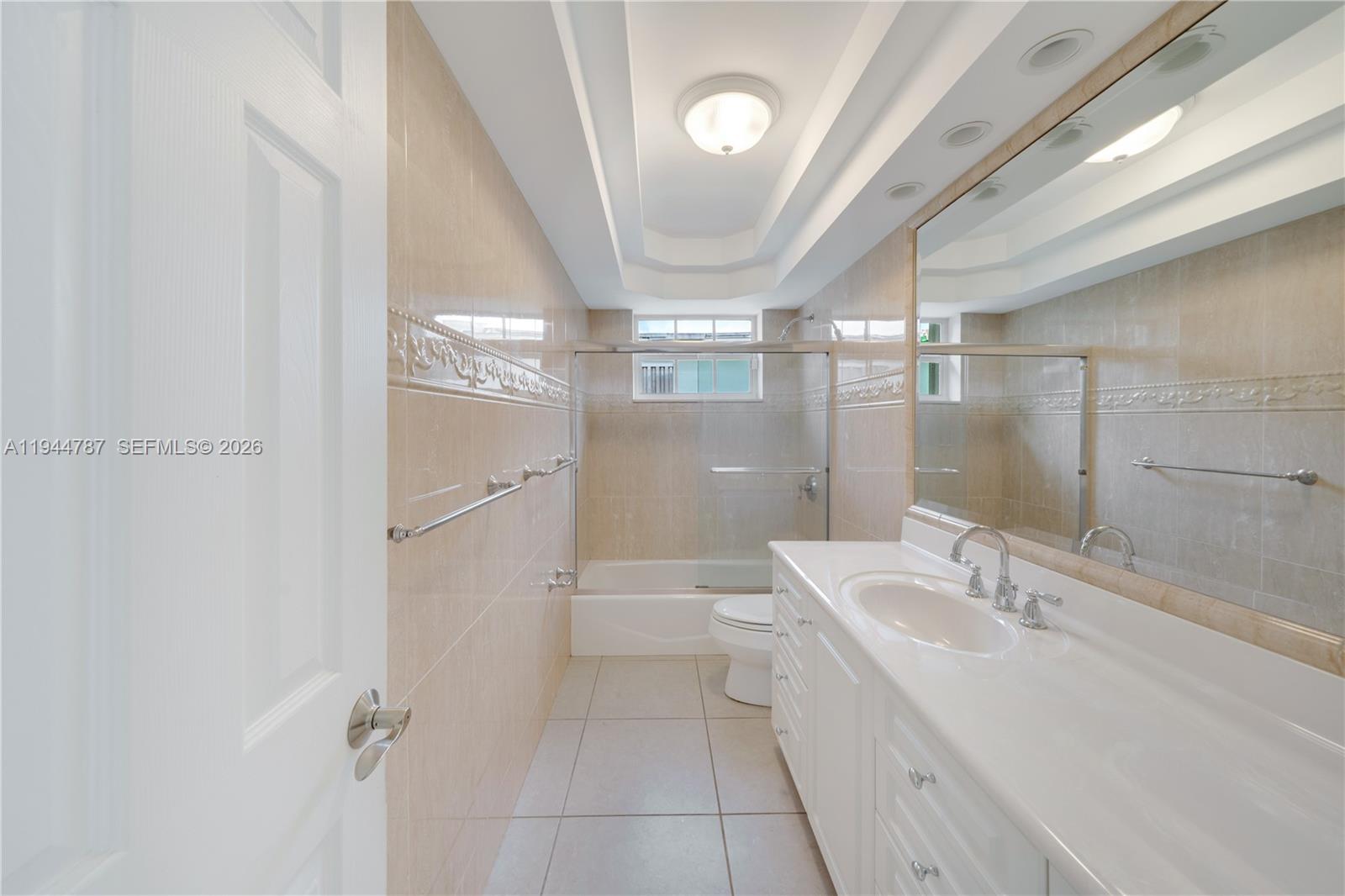 5524 Cleveland Street Hollywood, FL 33021 - Photo 24 of 36 a bathroom with a granite countertop sink a toilet and shower