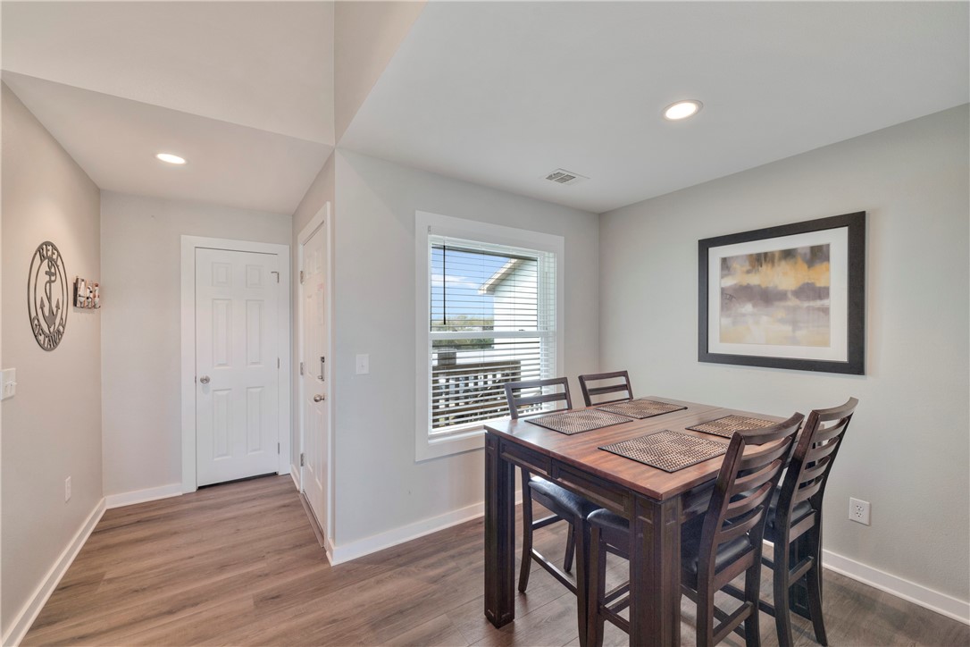 230 Cut-Off Road, Unit 204 Port Aransas, TX 78373 - Photo 8 of 37 a view of a dining room with furniture window and wooden floor