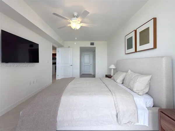 a bedroom with a bed and a flat screen tv