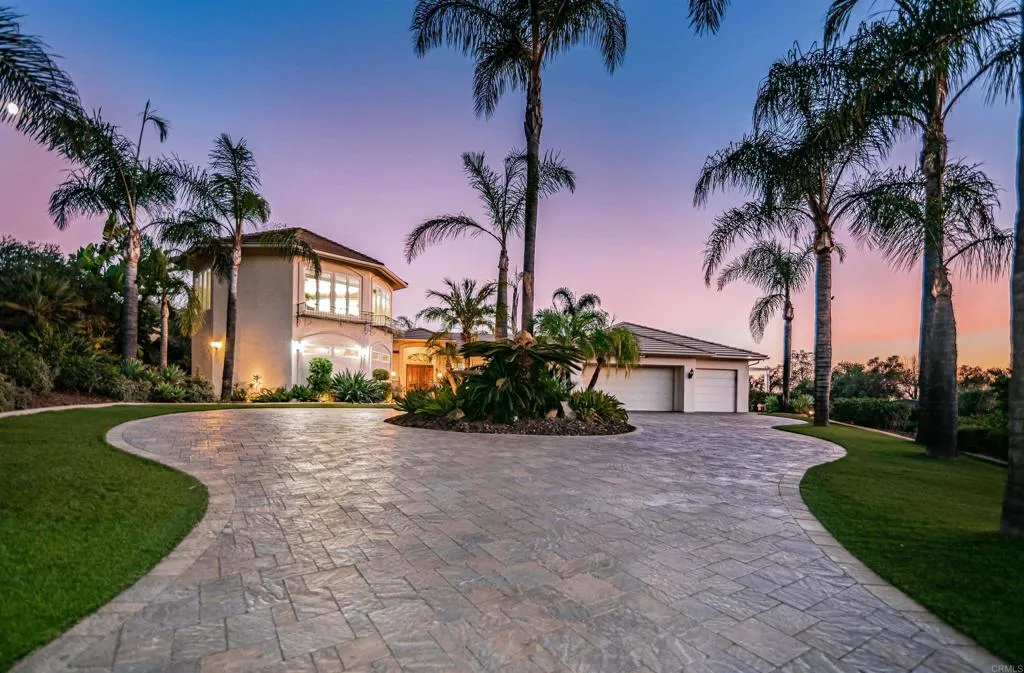 front view of a house with a yard and potted plants