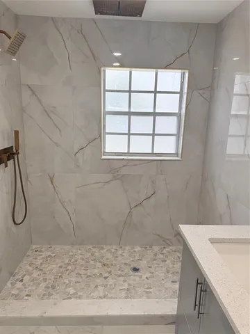 a bathroom with a sink window and shower