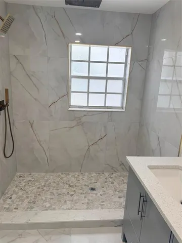 a bathroom with a sink and a window