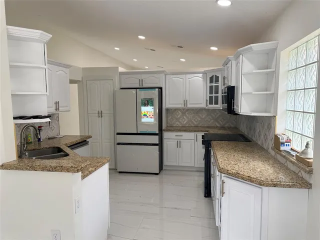 a kitchen with a sink stove and refrigerator