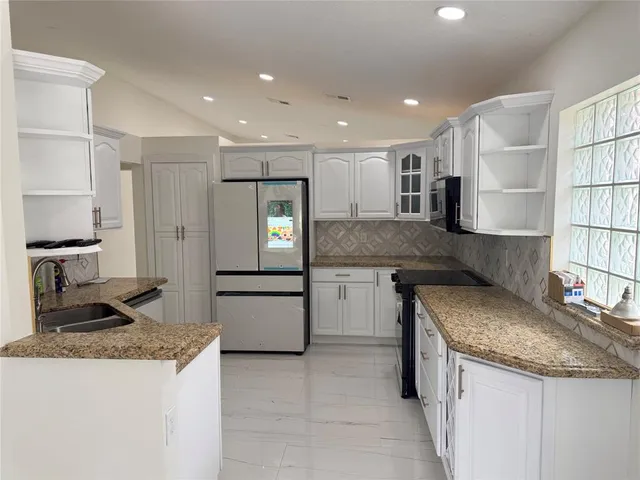 a kitchen with a sink stove and refrigerator