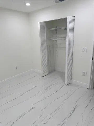 an empty room with closet area