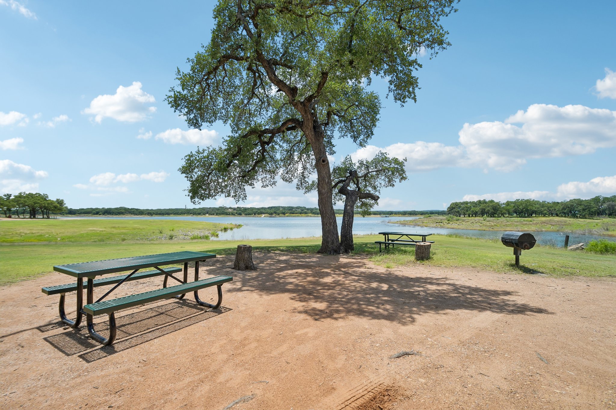 20609 Bridle Path Road Lago Vista, TX 78645 - Photo 27 of 30 A tranquil lakeside retreat with mature shade trees, offering perfect spots for outdoor dining and recreation.