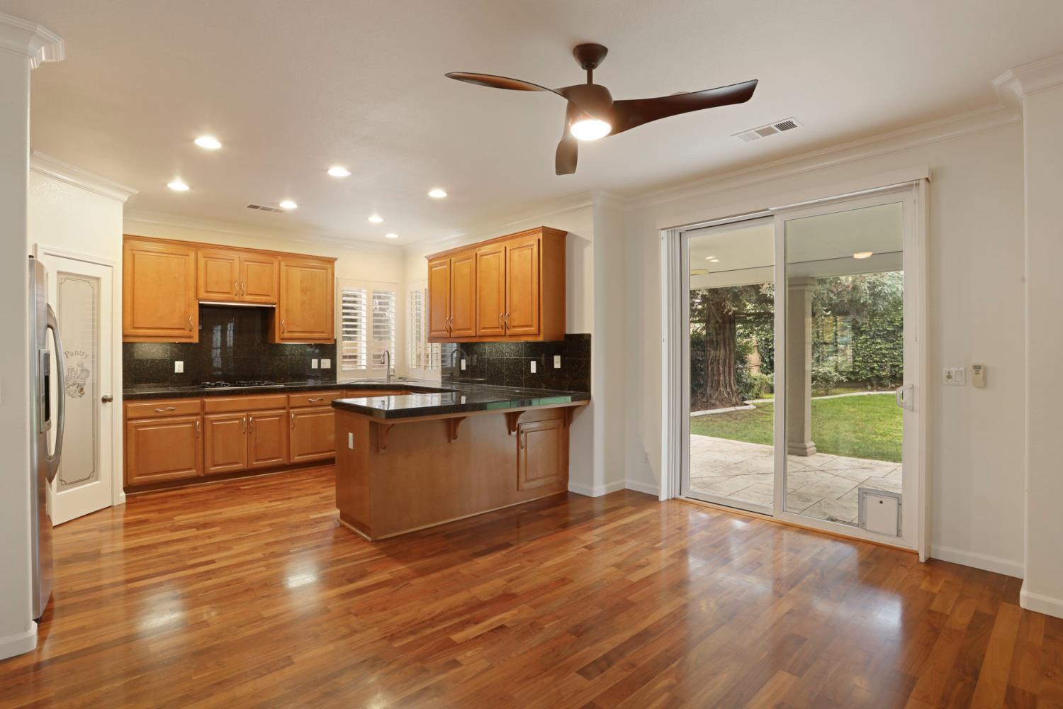 4305 Lourmarin Lane Modesto, CA 95356 - Photo 23 of 58 a kitchen with a refrigerator and a stove top oven