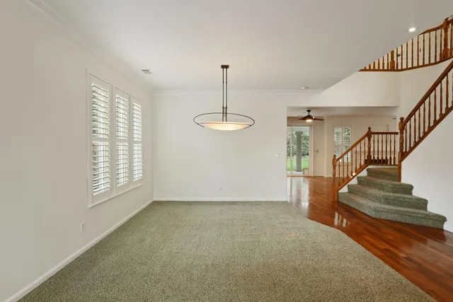 a kitchen with stainless steel appliances granite countertop a refrigerator a stove and a sink with wooden floor