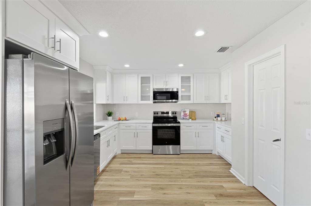 916 River Rapids Avenue Brandon, FL 33511 - Photo 17 of 61 a kitchen with stainless steel appliances kitchen island a refrigerator sink and stove