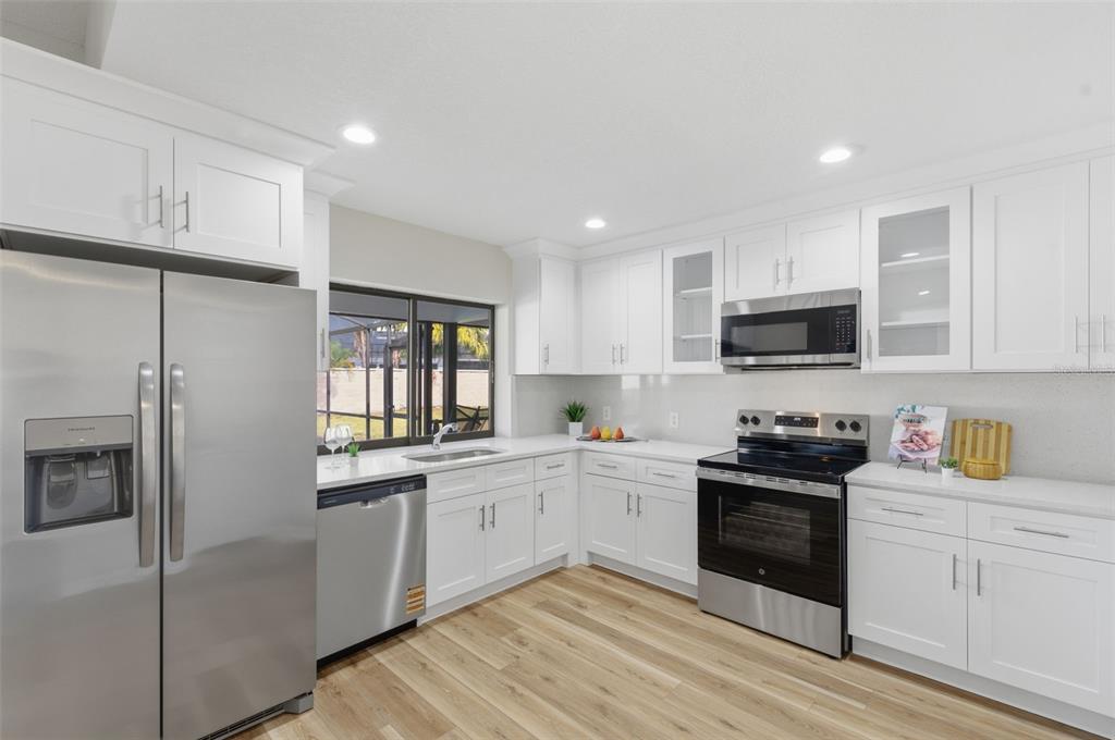 916 River Rapids Avenue Brandon, FL 33511 - Photo 18 of 61 a kitchen with stainless steel appliances granite countertop a stove sink and cabinets