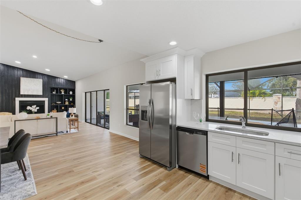 916 River Rapids Avenue Brandon, FL 33511 - Photo 19 of 61 a kitchen with stainless steel appliances granite countertop a refrigerator a stove and a wooden floors