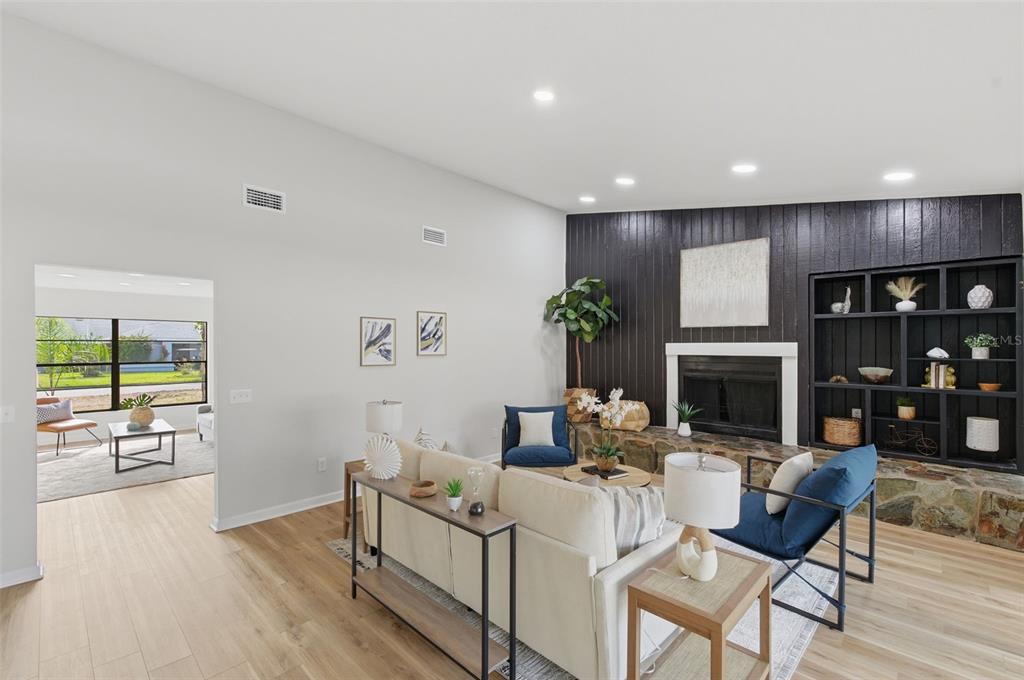 916 River Rapids Avenue Brandon, FL 33511 - Photo 21 of 61 a living room with fireplace furniture and a wooden floor