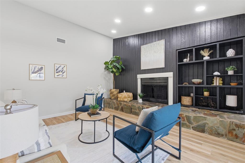 916 River Rapids Avenue Brandon, FL 33511 - Photo 24 of 61 a living room with furniture a bookshelf and a fireplace