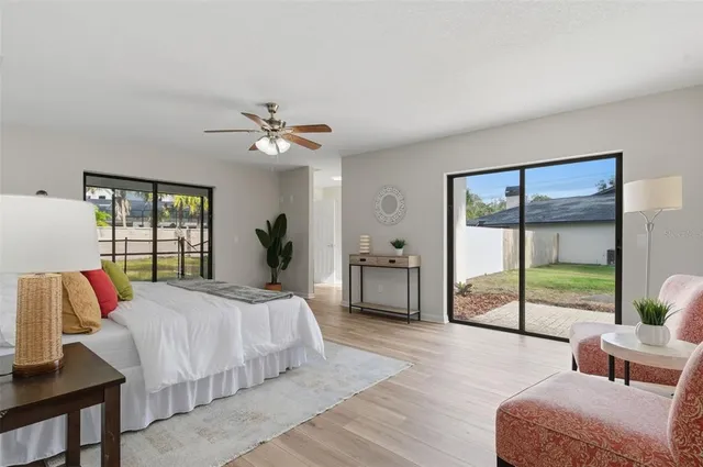 a bedroom with a bed chandelier and a window