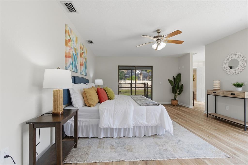 916 River Rapids Avenue Brandon, FL 33511 - Photo 28 of 61 a bedroom with a bed and wooden floor