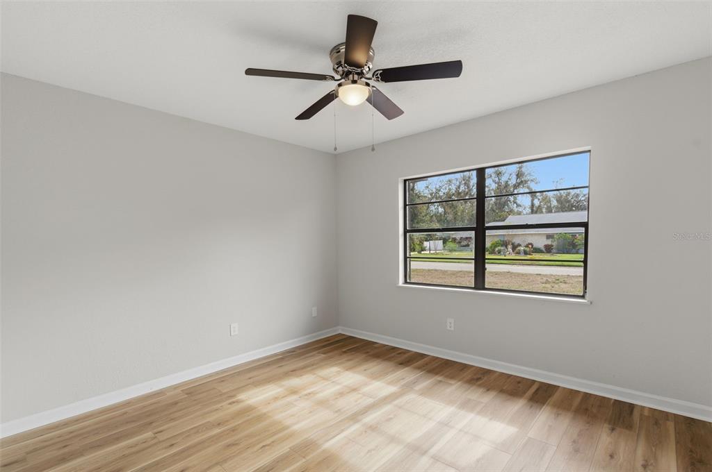 916 River Rapids Avenue Brandon, FL 33511 - Photo 36 of 61 a view of an empty room with a window and wooden floor