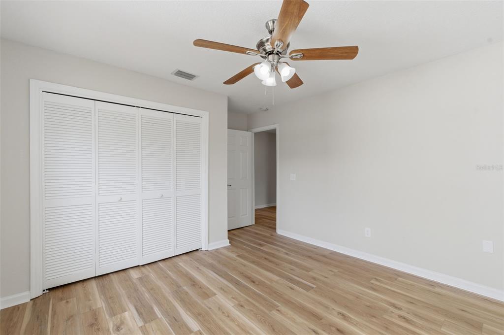 916 River Rapids Avenue Brandon, FL 33511 - Photo 39 of 61 an empty room with wooden floor closet and fan