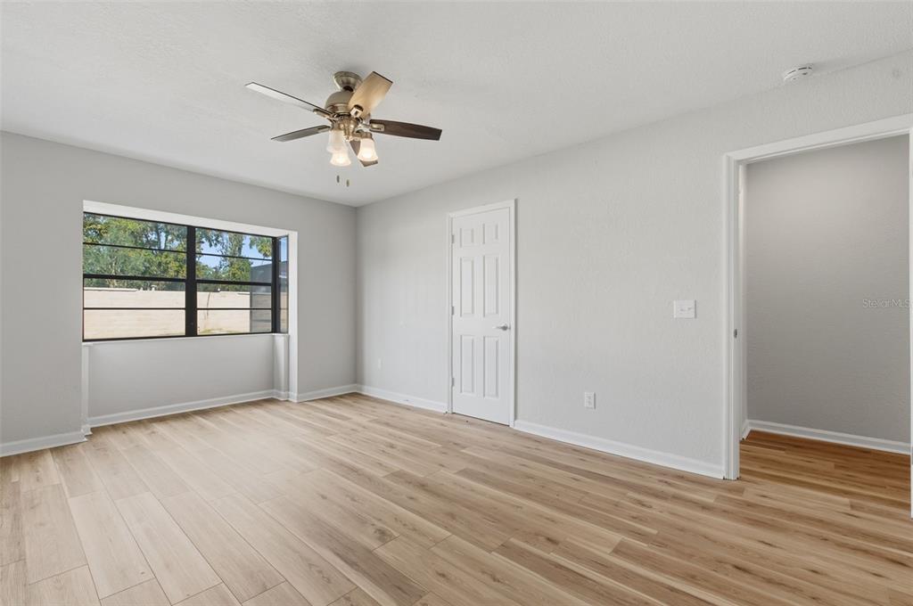 916 River Rapids Avenue Brandon, FL 33511 - Photo 44 of 61 a view of an empty room with wooden floor and a window