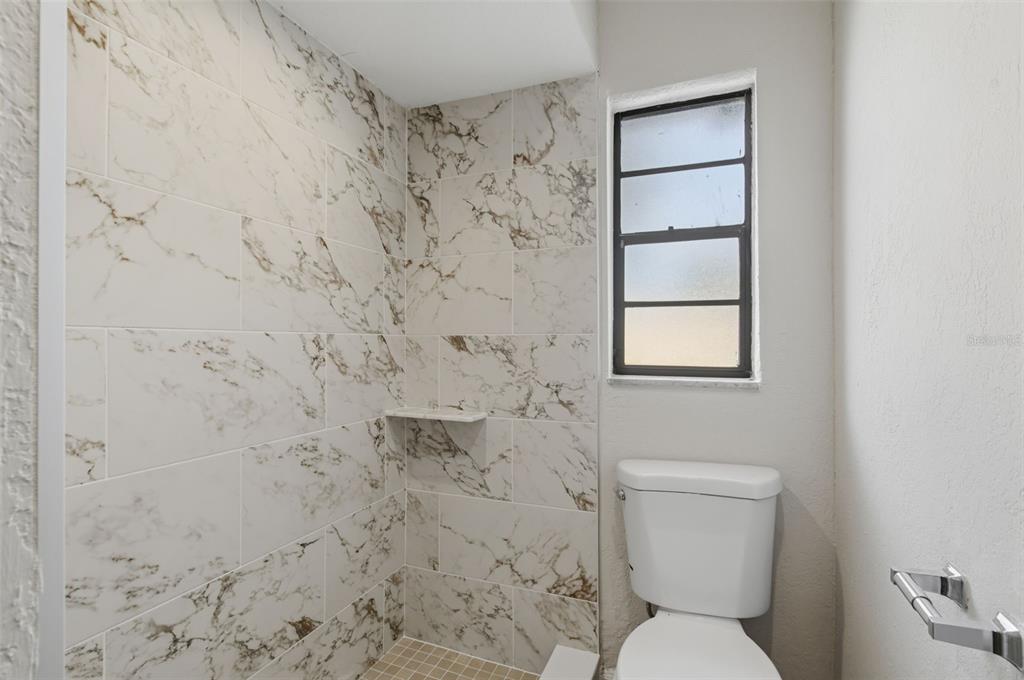 916 River Rapids Avenue Brandon, FL 33511 - Photo 47 of 61 a bathroom with a toilet and a shower curtain