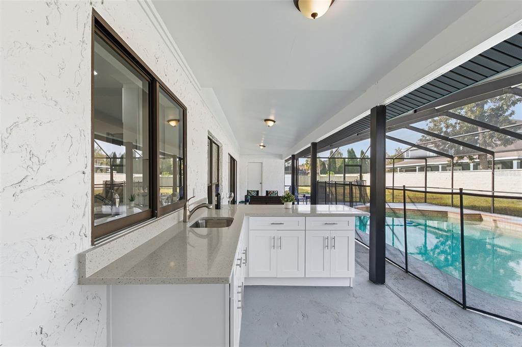 916 River Rapids Avenue Brandon, FL 33511 - Photo 52 of 61 a large white kitchen with granite countertop a sink and a large window