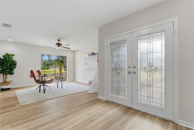 a living room with furniture and wooden floor