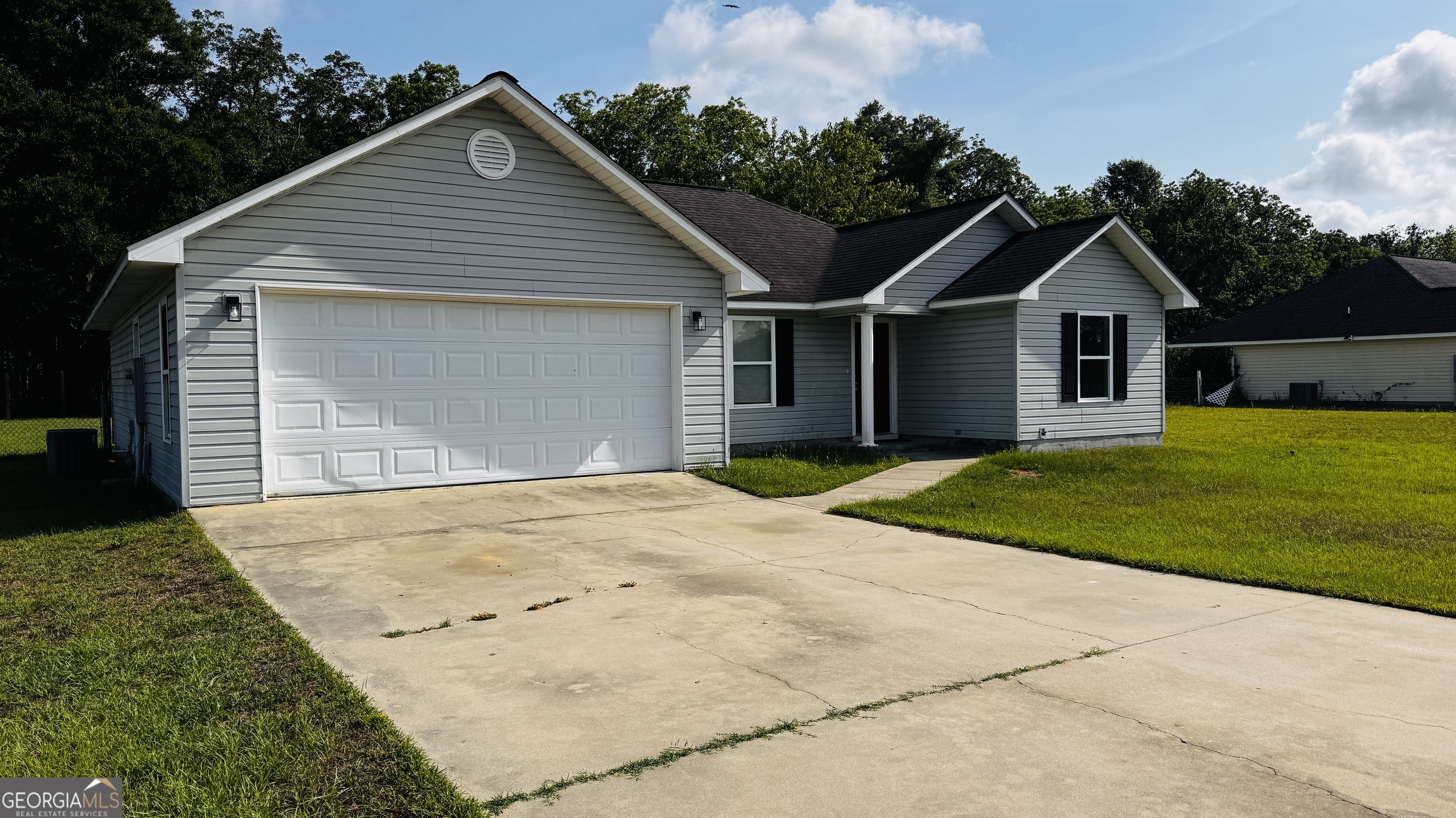 512 Antietum Road Collins, GA 30421 - Photo 2 of 16 a front view of a house with a garden and yard
