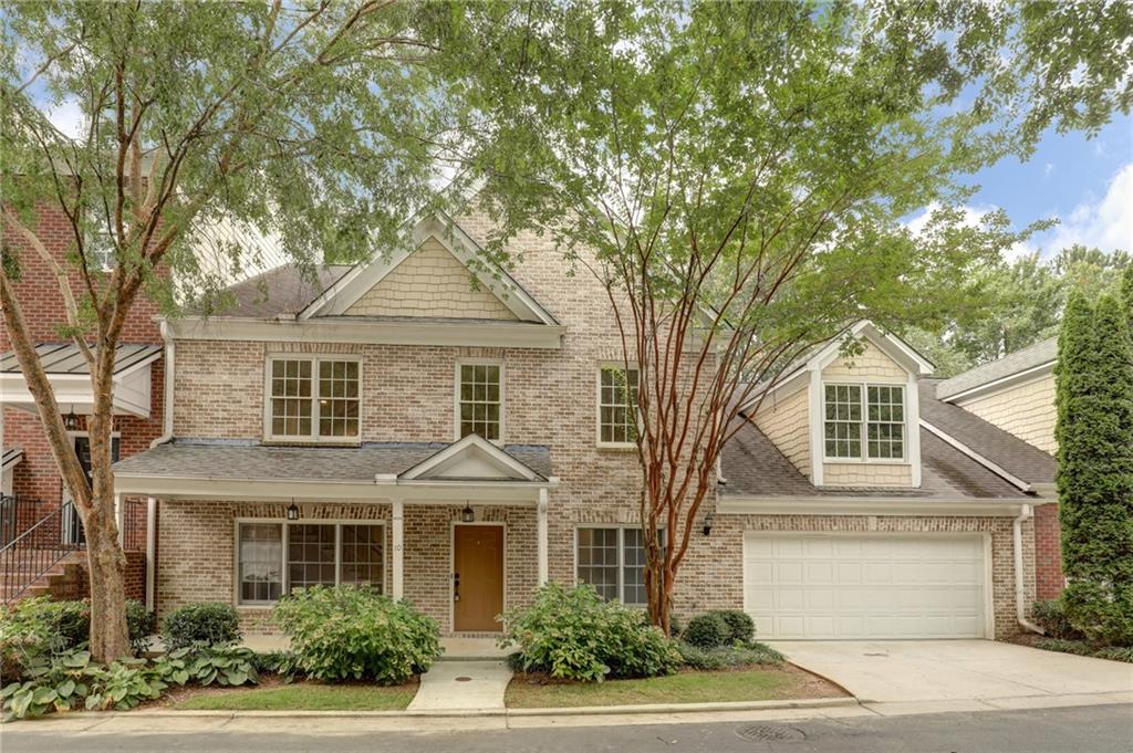 10090 Jones Bridge Road, Unit 10 Alpharetta, GA 30022 - Photo 1 of 1 a front view of a house with a garden