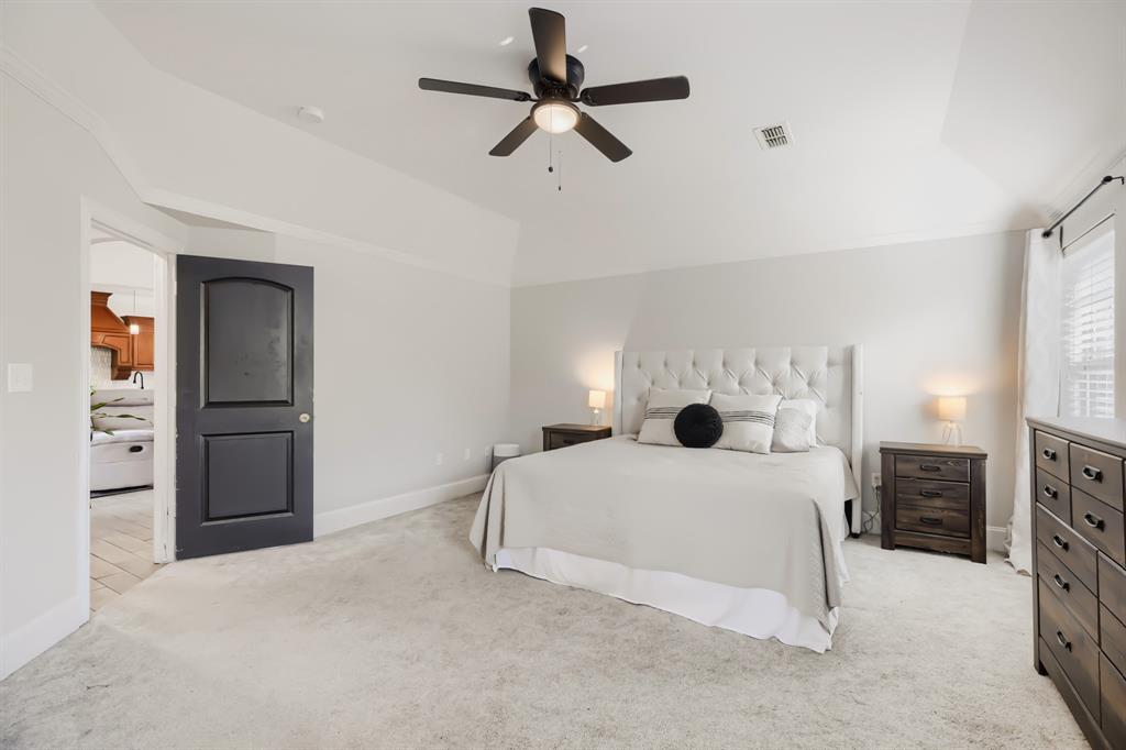 603 Ash Street Pilot Point, TX 76258 - Photo 17 of 28 Spacious room featuring light-colored carpeting, a tray ceiling, and a ceiling fan