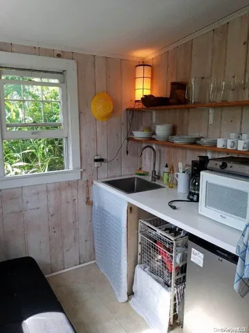 a kitchen with a sink cabinets and window