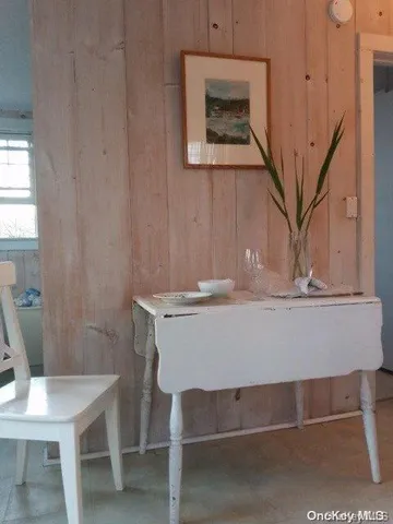 a view of a room with a table and chairs