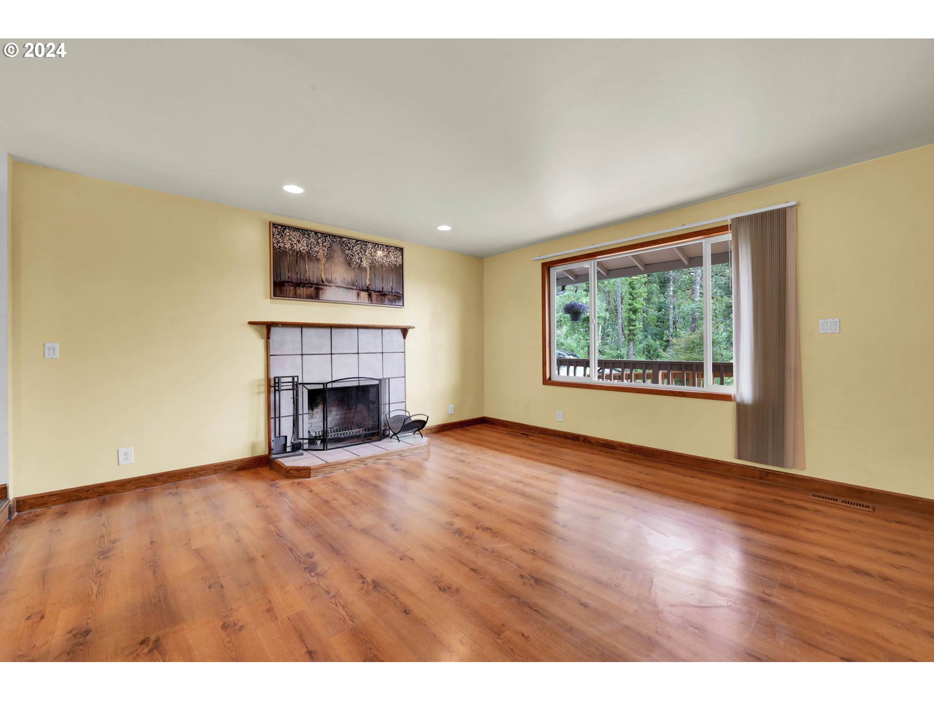 1037 South 70th Street Springfield, OR 97478 - Photo 6 of 44 a view of an empty room with a fireplace and a window